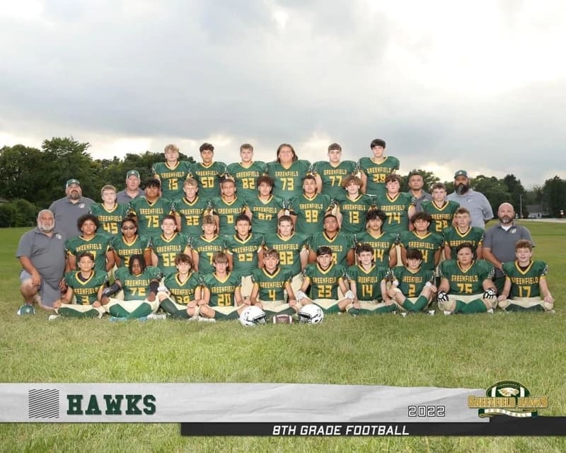 Greenfield Hawks football team in custom uniforms decorated by Ideal Logos and Awards